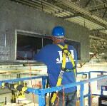 Cleaning Specialist Reaching Into Commercial Ducts