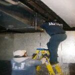 Duct Cleaning Specialist on a Ladder
