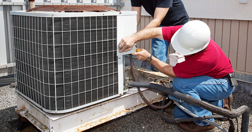 HVAC Technicians Checking AC Unit